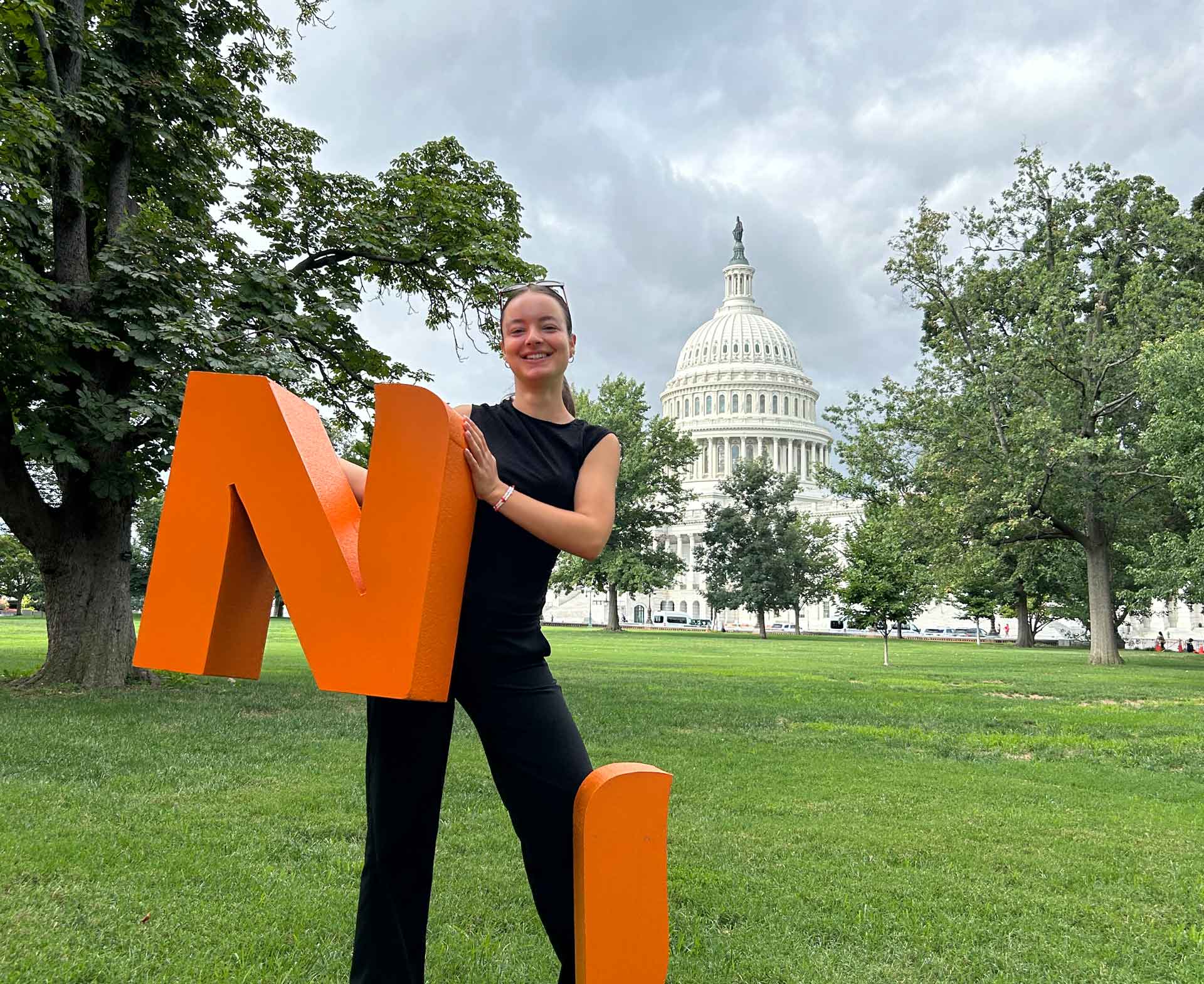 A student in front of the U.S. Capitol.